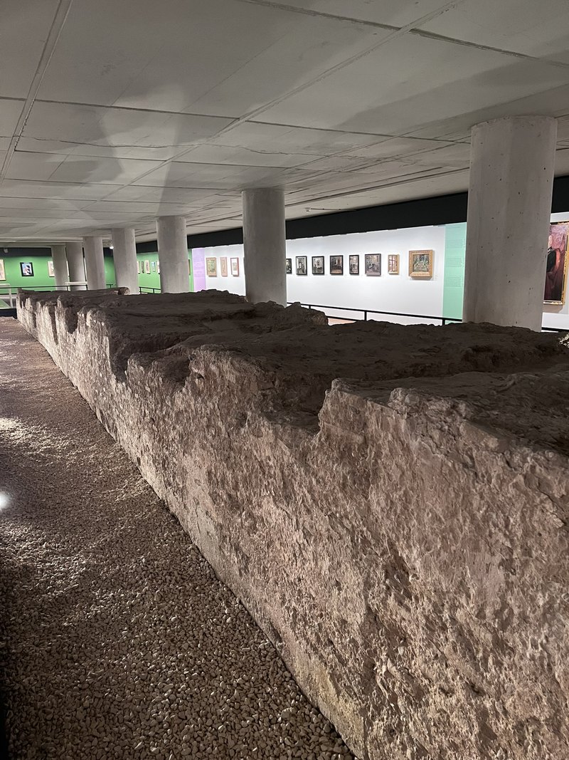 Section of Valencia's medieval city wall preserved beneath a modern museum building.